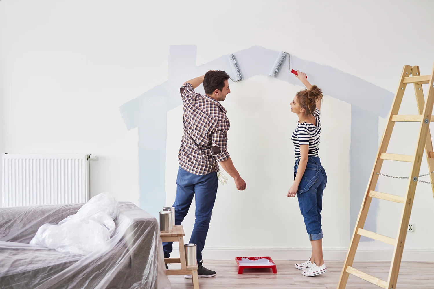 Couple painting home interior wall. Home Interior Painting Blog Post Featured Image